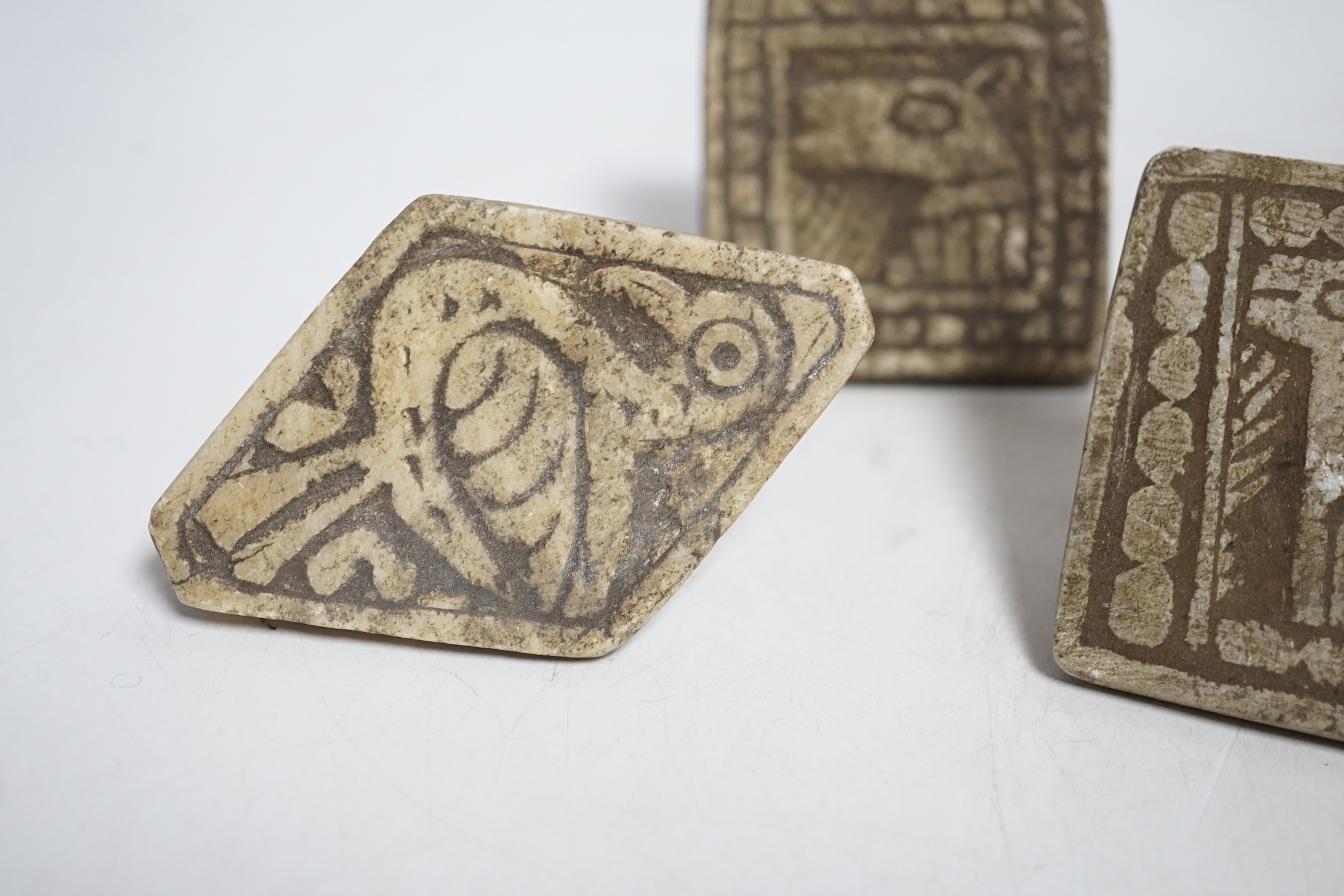 A group of five Middle eastern pottery moulds/stamps, largest, 10cm long